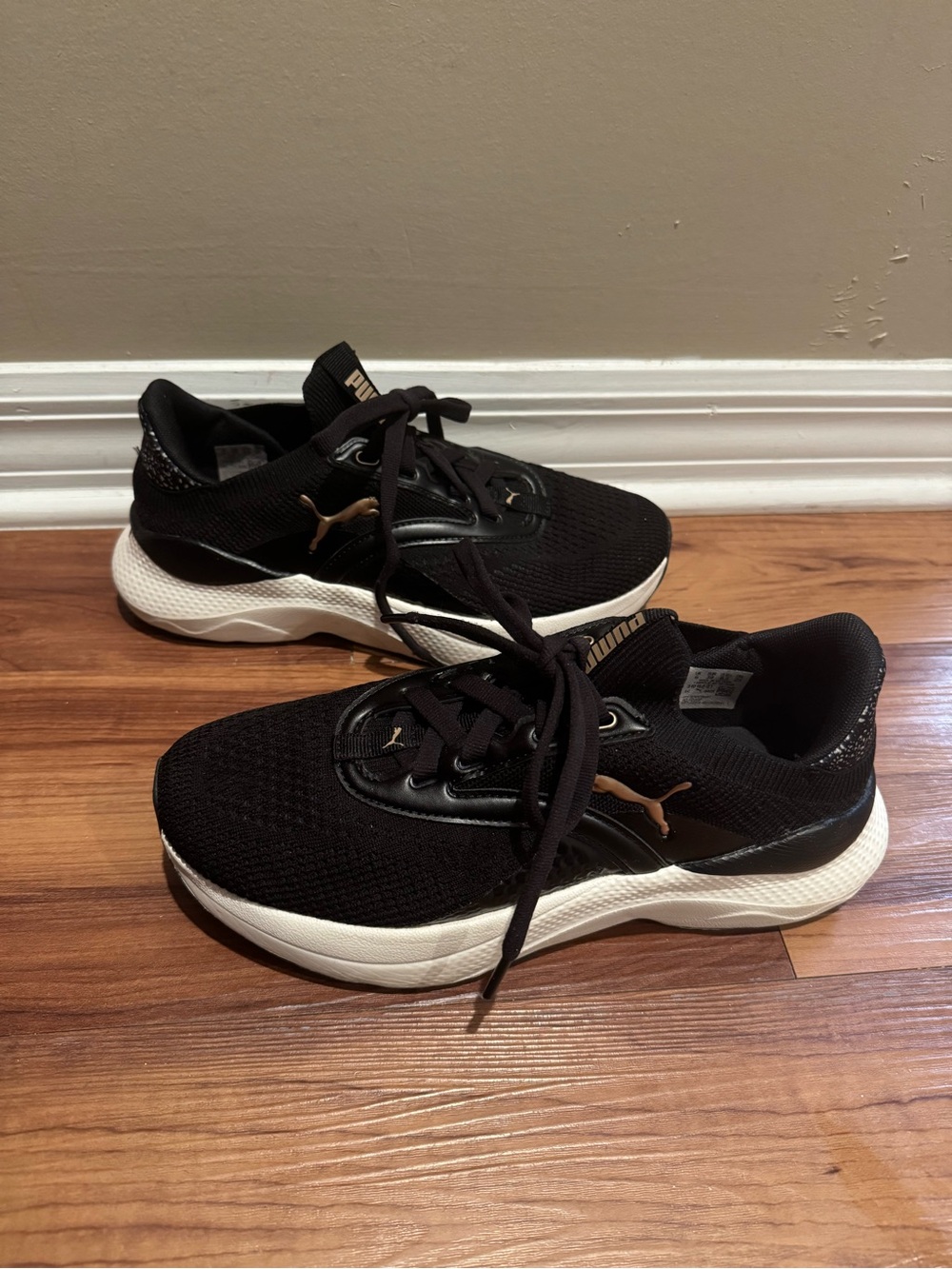Puma Women's Black Athletic Sneakers with White Sole and Gold Logo